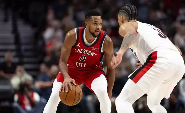 New Orleans Pelicans guard CJ McCollum, left, dribbles against Portland Trail Blazers forward Toumani Camara, right, during the second half of an NBA basketball game Sunday, Oct. 27, 2024, in Portland, Ore. (AP Photo/Howard Lao)