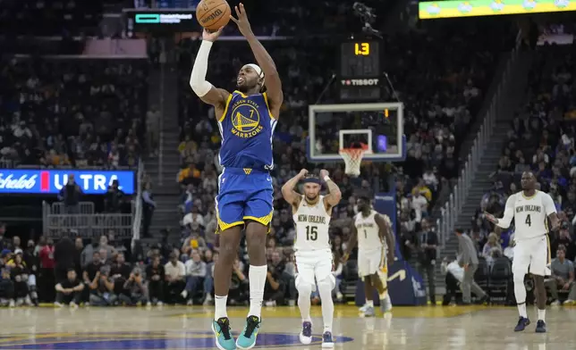 Golden State Warriors guard Buddy Hield (7) shoots a three-point basket at the first half buzzer during an NBA basketball game against the New Orleans Pelicans in San Francisco, Wednesday, Oct. 30, 2024. (AP Photo/Jeff Chiu)