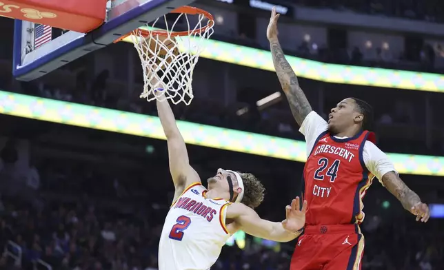 Golden State Warriors guard Brandin Podziemski (2) shoots against New Orleans Pelicans guard Jordan Hawkins (24) during the first half of an NBA basketball game in San Francisco, Tuesday, Oct. 29, 2024. (AP Photo/Jed Jacobsohn)