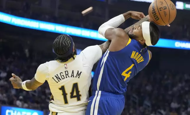 New Orleans Pelicans forward Brandon Ingram (14) reaches for the ball next to Golden State Warriors guard Moses Moody (4) during the first half of an NBA basketball game in San Francisco, Wednesday, Oct. 30, 2024. (AP Photo/Jeff Chiu)