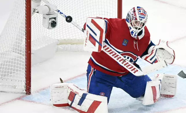 Montreal Canadiens goaltender Sam Montembeault makes a stick save during the second period of a NHL hockey game against the Pittsburgh Penguins in Montreal, Monday, Oct. 14, 2024. (Graham Hughes/The Canadian Press via AP)