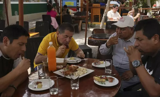 Costumers eat guinea pig at a restaurant in Lima, Peru, Thursday, Oct. 3, 2024. Guinea pigs, locally known as 'cuy,' have been traditionally raised for meat consumption since pre-Inca times. (AP Photo/Guadalupe Pardo)