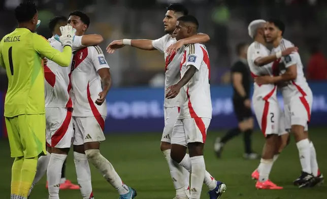 Players of Peru celebrate at the end of a qualifying soccer match for the FIFA World Cup 2026 against Uruguay at National Stadium in Lima, Peru, Friday, Oct. 11, 2024. Peru won 1-0. (AP Photo/Daniel Apuy)