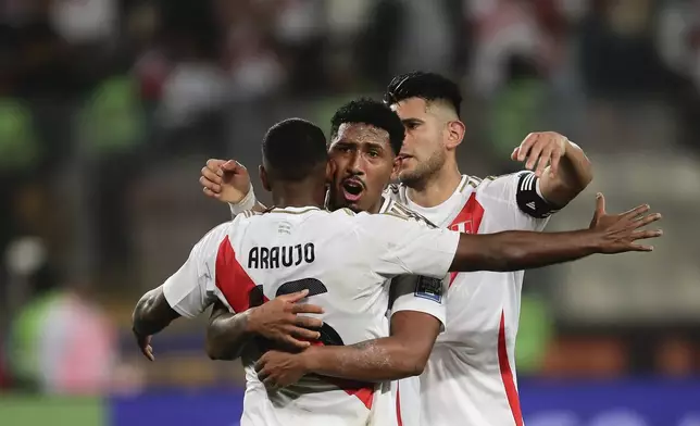 Players of Peru celebrate at the end of a qualifying soccer match for the FIFA World Cup 2026 against Uruguay at National Stadium in Lima, Peru, Friday, Oct. 11, 2024. Peru won 1-0. (AP Photo/Daniel Apuy)