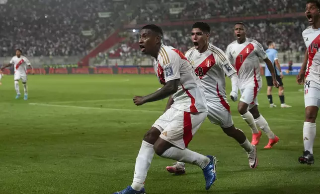 Peru's Miguel Araujo, left, celebrates scoring his side's opening goal against Uruguay during a qualifying soccer match for the FIFA World Cup 2026 at National Stadium in Lima, Peru, Friday, Oct. 11, 2024. (AP Photo/Guadalupe Pardo)