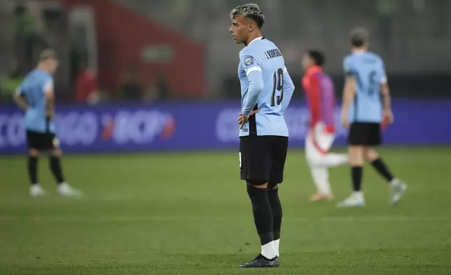 Players of Uruguay react after losing a qualifying soccer match for the FIFA World Cup 2026 against Peru at National Stadium in Lima, Peru, Friday, Oct. 11, 2024. Peru won 1-0. (AP Photo/Daniel Apuy)