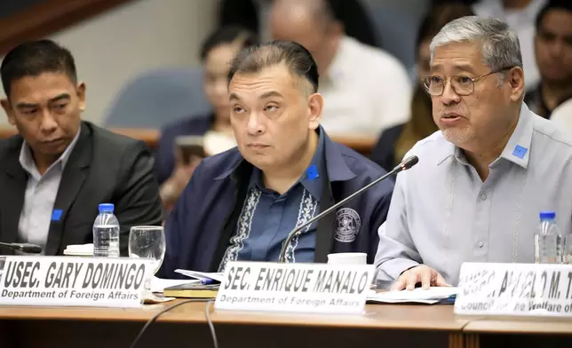 Philippine Foreign Affairs Secretary Enrique Manalo, right, talks beside Undersecretary Gary Domingo and Commission on Human Right Chairperson Richard Palpal-latoc, right, attend a senate inquiry for detained Filipino preacher Apollo Quiboloy at the Philippine Senate Wednesday, Oct. 23, 2024, in Manila, Philippines. (AP Photo/Aaron Favila)