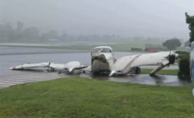 In this photo provided by the Civil Aviation Authority of the Philippines, a plane damaged by powerful Typhoon Krathon lies at the Basco airport as the typhoon hit Basco, Batanes province, northern Philippines Monday, Sept. 30, 2024. (Civil Aviation Authority of the Philippines via AP)