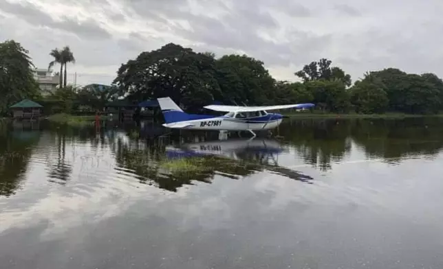 In this photo provided by the Civil Aviation Authority of the Philippines, a plane lies on a flooded airport caused by powerful Typhoon Krathon at San Fernando, La Union province, northern Philippines Monday, Sept. 30, 2024. (Civil Aviation Authority of the Philippines via AP)