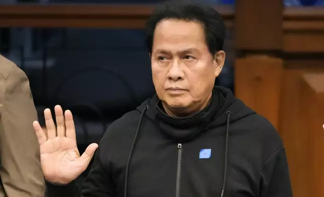 Apollo Quiboloy, a detained Filipino preacher accused of sexual abuse and human trafficking in the Philippines and similar charges in the United States, takes his oath as he attends a hearing at the Philippine Senate on Wednesday, Oct. 23, 2024, in Manila, Philippines. (AP Photo/Aaron Favila)