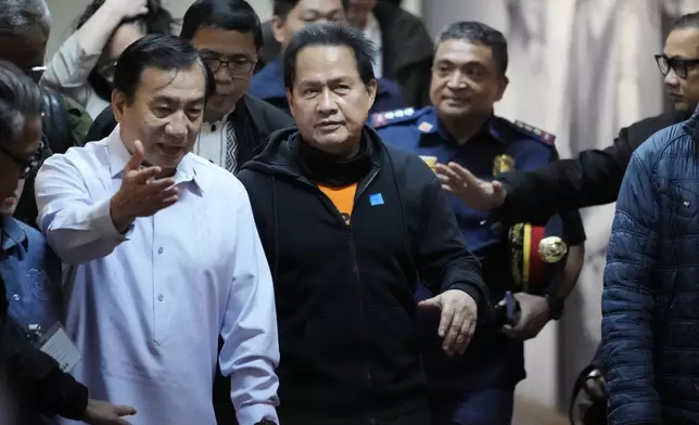 Apollo Quiboloy, center, a detained Filipino preacher accused of sexual abuse and human trafficking in the Philippines and similar charges in the United States, arrives to attend a senate inquiry at the Philippine Senate on Wednesday, Oct. 23, 2024, in Manila, Philippines. (AP Photo/Aaron Favila)