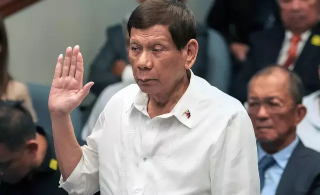 Former Philippine President Rodrigo Duterte takes oath during a senate inquiry on the so-called war on drugs during his administration at the Philippine Senate Monday, Oct. 28, 2024, in Manila, Philippines. (AP Photo/Aaron Favila)