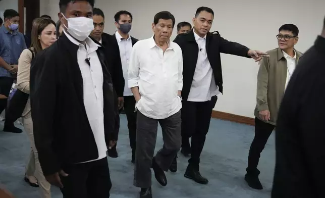 Former Philippine President Rodrigo Duterte walks during a senate investigation on the war on the drugs during his administration, at the Philippine Senate, Monday, Oct. 28, 2024, in Manila, Philippines. (AP Photo/Aaron Favila)