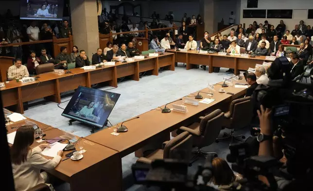 Senator Risa Hontiveros, left, asks questions during a senate investigation on the war on the drugs during the administration of former Philippine President Rodrigo Duterte at the Philippine Senate Monday, Oct. 28, 2024, in Manila, Philippines. (AP Photo/Aaron Favila)