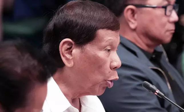 Former Philippine President Rodrigo Duterte gestures during a senate investigation on the war on the drugs during his administration, at the Philippine Senate, Monday, Oct. 28, 2024, in Manila, Philippines. (AP Photo/Aaron Favila)