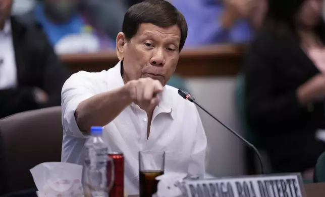 Former Philippine President Rodrigo Duterte gestures during a senate investigation on the war on the drugs during his administration, at the Philippine Senate, Monday, Oct. 28, 2024, in Manila, Philippines. (AP Photo/Aaron Favila)