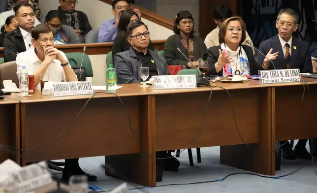 Former senator Leila de Lima, right, speaks beside former Philippine President Rodrigo Duterte, left, during a senate inquiry on the so-called war on drugs during his administration at the Philippine Senate Monday, Oct. 28, 2024, in Manila, Philippines. (AP Photo/Aaron Favila)