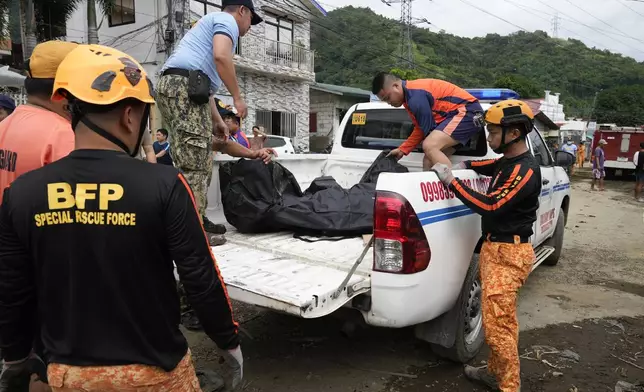 A body is recovered by rescuers after a recent landslide triggered by Tropical Storm Trami struck Talisay, Batangas province, Philippines which thousands homeless and several villagers dead on Saturday, Oct. 26, 2024. (AP Photo/Aaron Favila)