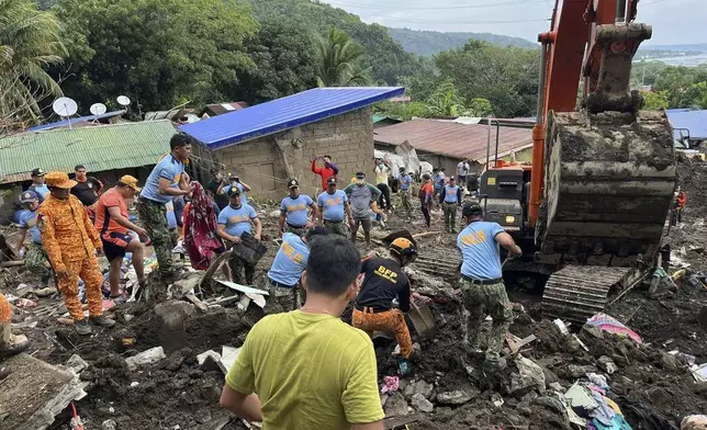 Volunteers continue rescue operations after a recent landslide triggered by Tropical Storm Trami struck Talisay, Batangas province, Philippines leaving thousands homeless and several villagers dead on Saturday, Oct. 26, 2024. (AP Photo/Jim Gomez)