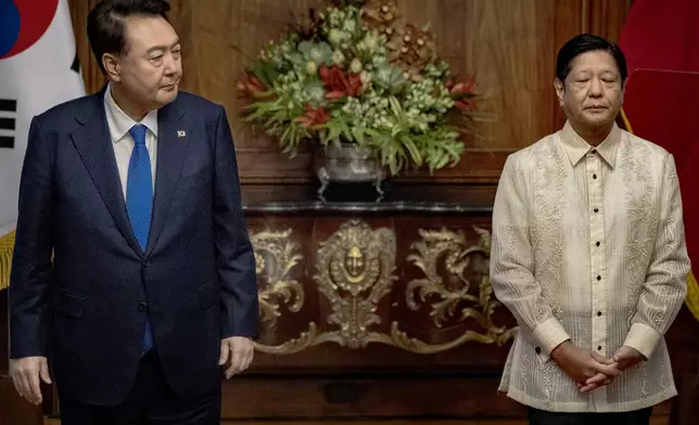 South Korean President Yoon Suk Yeol, left, looks at Philippine President Ferdinand Marcos Jr. during a meeting at the Malacanang Palace Monday, Oct. 7, 2024 in Manila, Philippines. (Ezra Acayan/Pool Photo via AP)