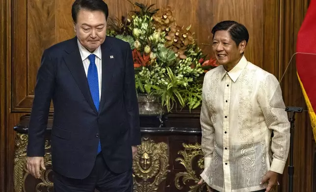 South Korean President Yoon Suk Yeol, left, meets with Philippine President Ferdinand Marcos Jr. at the Malacanang Palace Monday, Oct. 7, 2024 in Manila, Philippines. (Ezra Acayan/Pool Photo via AP)