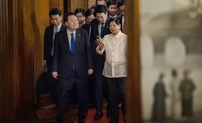 Philippine President Ferdinand Marcos Jr., right, meets with South Korean President Yoon Suk Yeol, left, at the Malacanang Palace Monday, Oct. 7, 2024 in Manila, Philippines. (Ezra Acayan/Pool Photo via AP)