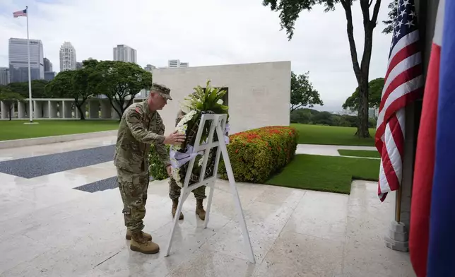 U.S. Maj. Gen. Marcus Evans, left, commanding general of the U.S. Army's 25th Infantry Division and Sgt. Major Shaun Curry arrange a wreath during rites to honor American soldiers died during World War II at the Manila American Cemetery and Memorial in Taguig, Philippines Monday, Oct. 21, 2024. (AP Photo/Aaron Favila)