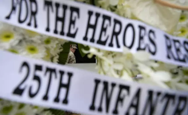 An American soldier walks past a wreath during ceremonies to honor American soldiers died during World War II at the Manila American Cemetery and Memorial in Taguig, Philippines Monday, Oct. 21, 2024. (AP Photo/Aaron Favila)