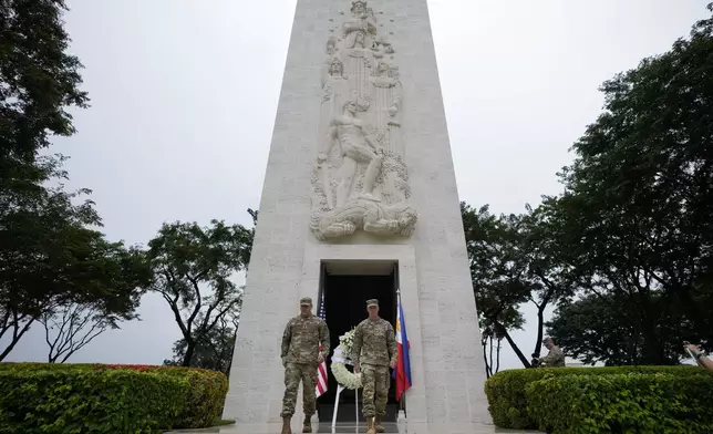 U.S. Maj. Gen. Marcus Evans, right, commanding general of the U.S. Army's 25th Infantry Division and Sgt. Major Shaun Curry walk after a wreath laying rite to honor American soldiers died during World War II at the Manila American Cemetery and Memorial in Taguig, Philippines Monday, Oct. 21, 2024. (AP Photo/Aaron Favila)