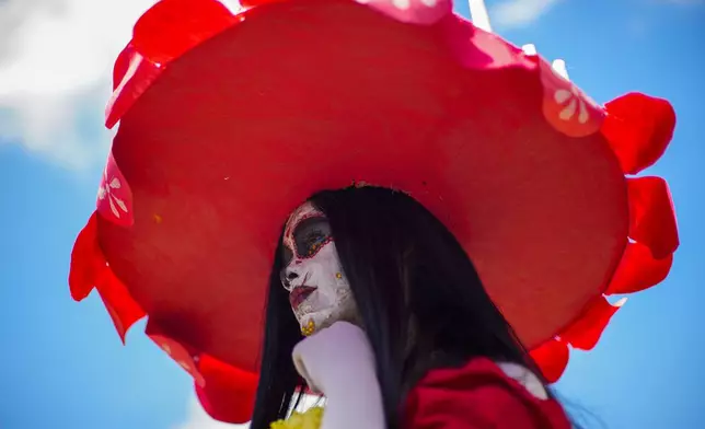 A reveler attends the annual zombie parade in Santiago, Chile, Sunday, Oct. 20, 2024. (AP Photo/Esteban Felix)