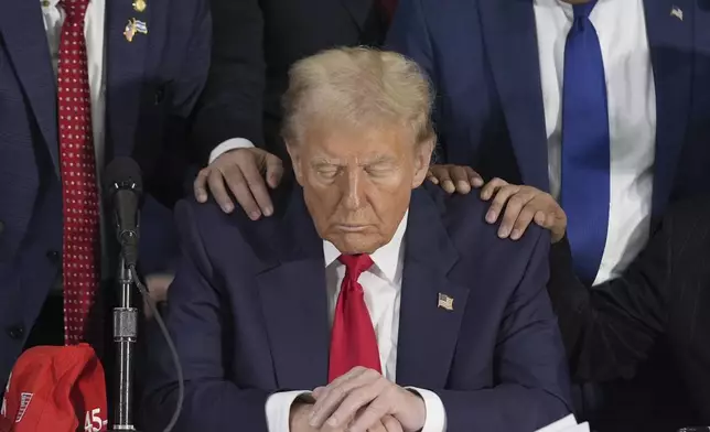 Latino leaders pray with Republican presidential nominee former President Donald Trump as he participates in a Latino leader roundtable, Tuesday, Oct. 22, 2024 in Doral, Fla. (AP Photo/Alex Brandon)