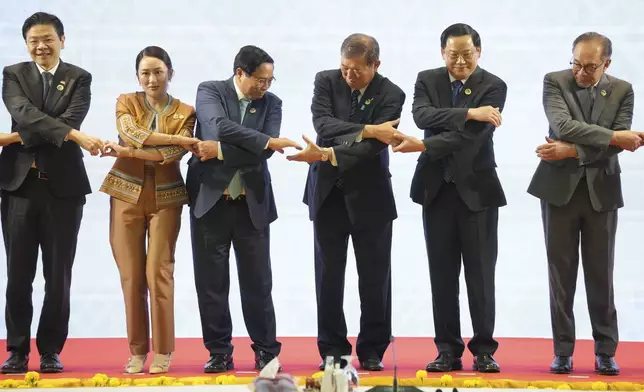 From left, Singapore's Prime Minister Lawrence Wong, Thailand's Prime Minister Paetongtarn Shinawatra, Vietnam's Prime Minister Pham Minh Chinh, Japanese Prime Minister Shigeru Ishiba, Laos' Prime Minister Sonexay Siphandone, and Malaysia's Prime Minister Anwar Ibrahim hold hands for a photo session during the 27th Association of Southeast Asian Nations (ASEAN)-Japan Summit in Vientiane, Laos, Thursday, Oct. 10, 2024. (AP Photo/Dita Alangkara)