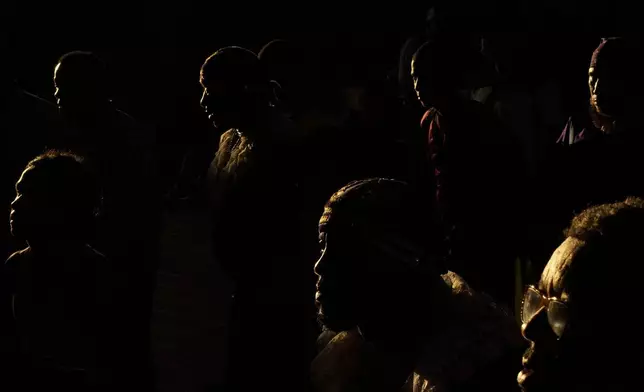 Pilgrims arrive inside San Felipe Church to honor the Black Christ in Portobelo, Panama, early Monday, Oct. 21, 2024, during a festival celebrating the iconic statue that was found on the shore in 1658. (AP Photo/Matias Delacroix)