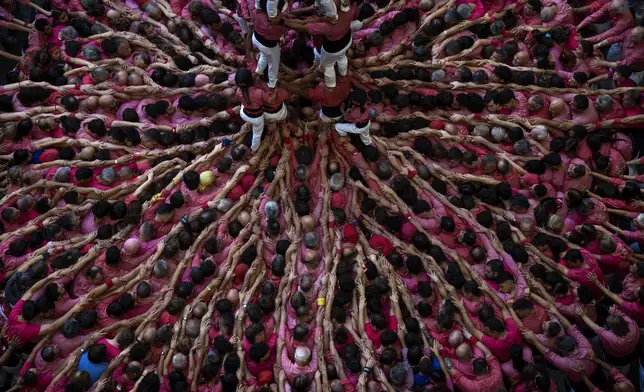 Members of "Moixiganguers d'Igualada" form a "Castell" or human tower, during the 29th Human Tower Competition in Tarragona, Spain, Sunday, Oct. 6, 2024. (AP Photo/Emilio Morenatti)