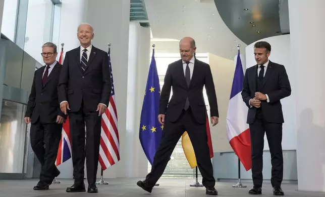 Prime Minister Keir Starmer of the United Kingdom, US President Joe Biden, Chancellor Olaf Scholz of Germany, and President Emmanuel Macron of France, from left, arrive for a Family photo during a meeting at the Chancellery in Berlin, Germany, Friday, Oct. 18, 2024. (AP Photo/Markus Schreiber)