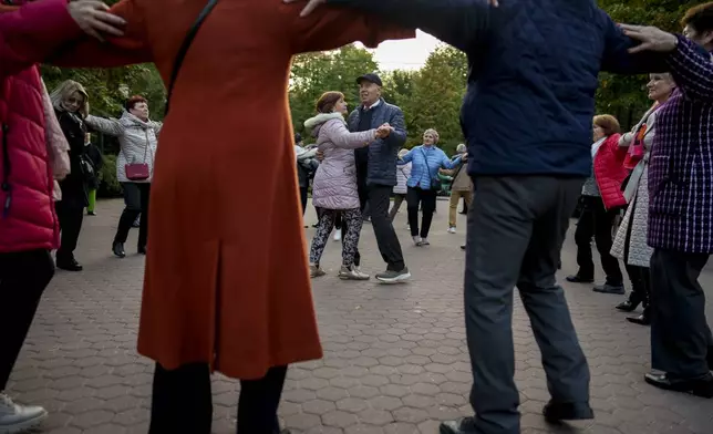 Retirees dance during a weekly event in a park in Chisinau, Moldova, Saturday, Oct. 19, 2024. (AP Photo/Vadim Ghirda)