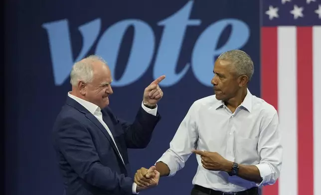 Democratic vice presidential nominee Minnesota Gov. Tim Walz, left, and former President Barack Obama shake hands at a campaign event Tuesday, Oct. 22, 2024, in Madison, Wis. (AP Photo/Morry Gash)