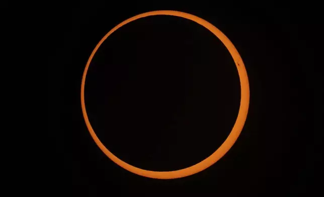 The moon moves across the sun during an annular solar eclipse in Tahai, Rapa Nui, or Easter Island, Chile, Wednesday, Oct. 2, 2024. (AP Photo/Esteban Felix)