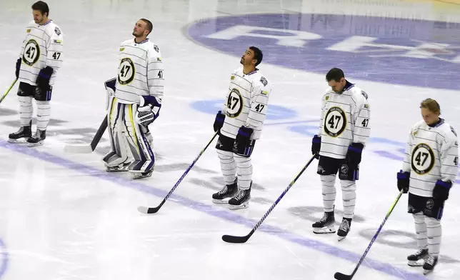 FILE - Manchester Storm players wearing number 47, Adam Johnson's number, pay tribute before the Ice Hockey Adam Johnson memorial game between Nottingham Panthers and Manchester Storm at the Motorpoint Arena, Nottingham, England, Nov. 18, 2023. (AP Photo/Rui Vieira, File)