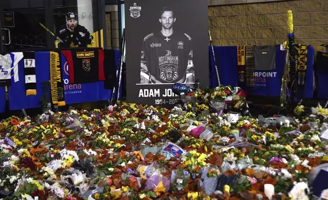 FILE - Flower tributes for Nottingham Panthers player Adam Johnson rest outside the Motorpoint Arena before a memorial ice hockey game between Nottingham Panthers and Manchester Storm in Nottingham, England, Nov. 18, 2023. (AP Photo/Rui Vieira, File)