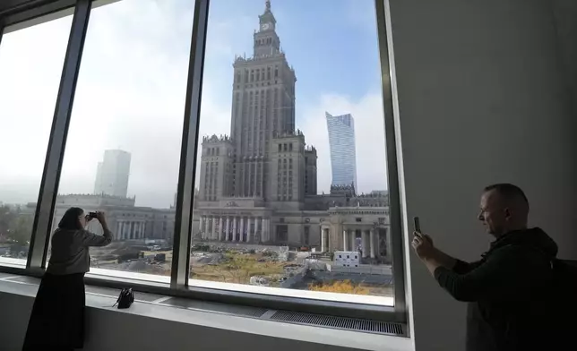 People look out of the window of the Museum of Modern Art in Warsaw, Poland, on Thursday Oct. 24, 2024. (AP Photo/Czarek Sokolowski)