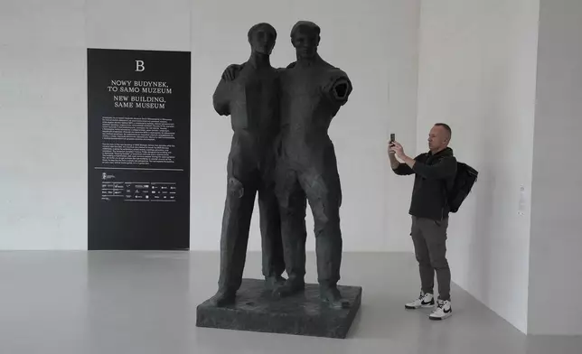 A man photographs a sculpture in the Museum of Modern Art in Warsaw, Poland, on Thursday Oct. 24, 2024. (AP Photo/Czarek Sokolowski)