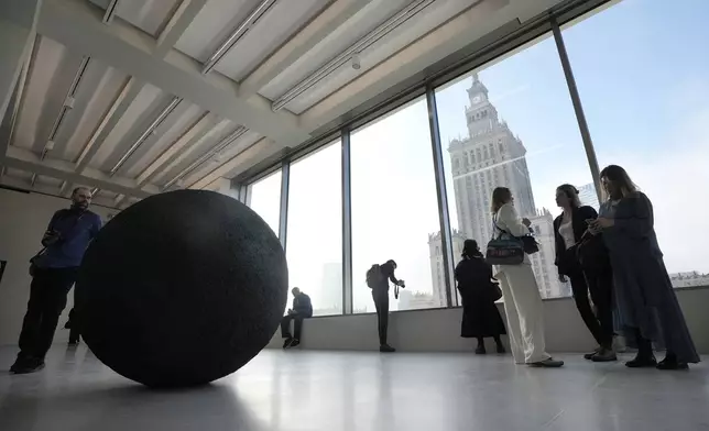 People look out of the window of the Museum of Modern Art in Warsaw, Poland, on Thursday Oct. 24, 2024. (AP Photo/Czarek Sokolowski)