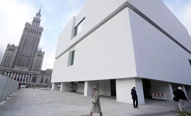 People walks near the around the Museum of Modern Art in Warsaw, Poland, on Thursday Oct. 24, 2024. (AP Photo/Czarek Sokolowski)