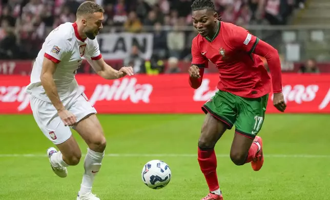 Poland's Sebastian Walukiewicz, left, and Portugal's Rafael Leao vie for the ball during the UEFA Nations League soccer match between Poland and Portugal at Narodowy stadium in Warsaw, Poland, Saturday, Oct. 12, 2024. (AP Photo/Czarek Sokolowski)