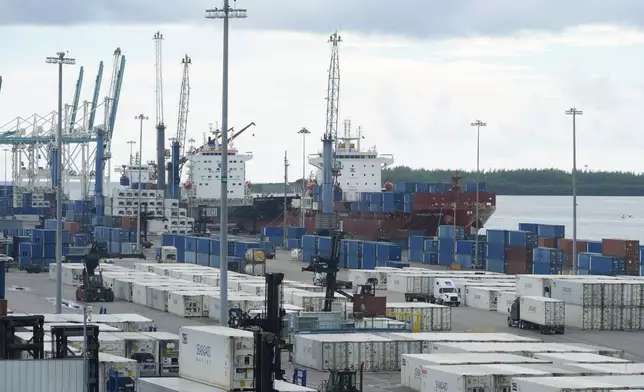 Dockworkers return to work at Port Miami, after the union representing 45,000 striking U.S. dockworkers reached a deal to suspend a three-day strike, Friday, Oct. 4, 2024, in Miami. (AP Photo/Marta Lavandier)