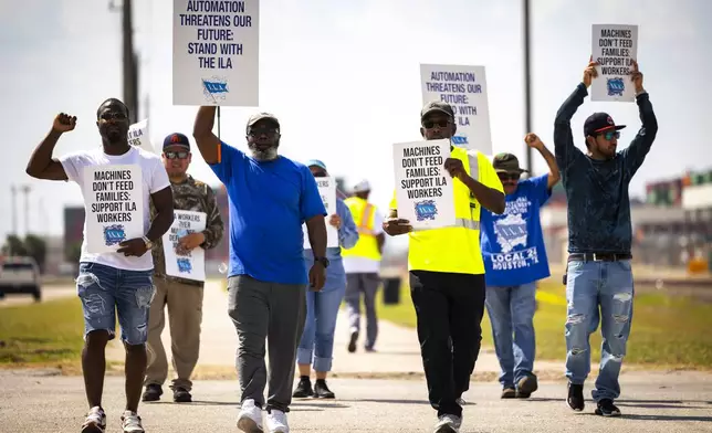 Longshoremen walk the picket line at the Barbours Cut Container Terminal during the first day of a dockworkers strike on Tuesday, Oct. 1, 2024, in Houston. (AP Photo/Annie Mulligan)