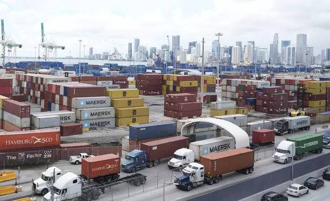 Trucks line up to enter Port Miami, after the union representing 45,000 striking U.S. dockworkers reached a deal to suspend a three-day strike, Friday, Oct. 4, 2024, in Miami. (AP Photo/Marta Lavandier)