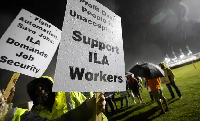 Hundreds of longshoremen strike together outside of the Virginia International Gateway in Portsmouth, Va., Tuesday, Oct. 1, 2024. (Billy Schuerman/The Virginian-Pilot via AP)