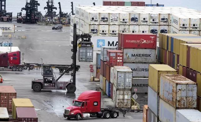 Dockworkers return to work at Port Miami, Friday, Oct. 4, 2024, in Miami, after the union representing 45,000 striking U.S. dockworkers at East and Gulf coast ports has reached a deal to suspend a three-day strike until Jan. 15 to provide time to negotiate a new contract. (AP Photo/Marta Lavandier)